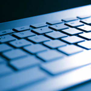 A close up of a laptop keyboard with a blue background.